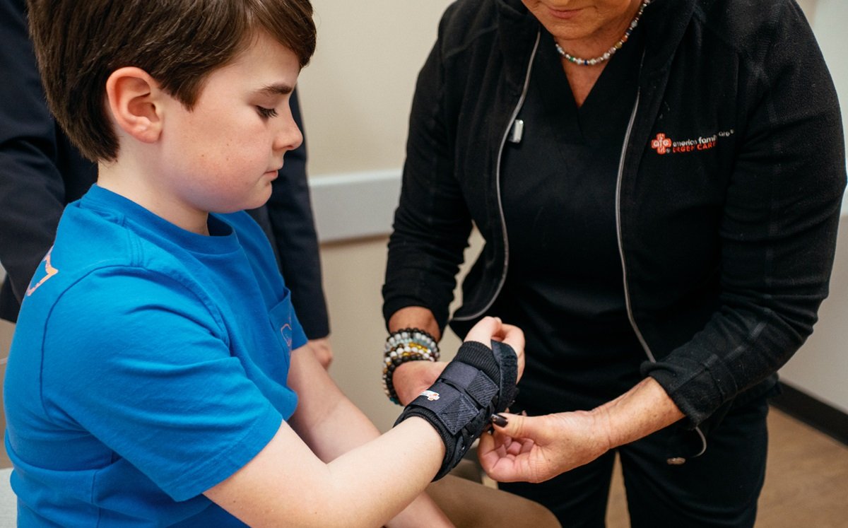 Medical provider putting a wrist splint on a child patient
