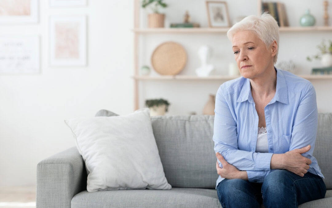 Discouraged older woman suffering from persistent COVID symptoms.